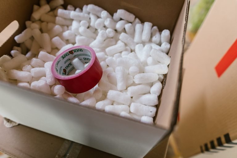 red scotch tape inside a box full of polystyrene